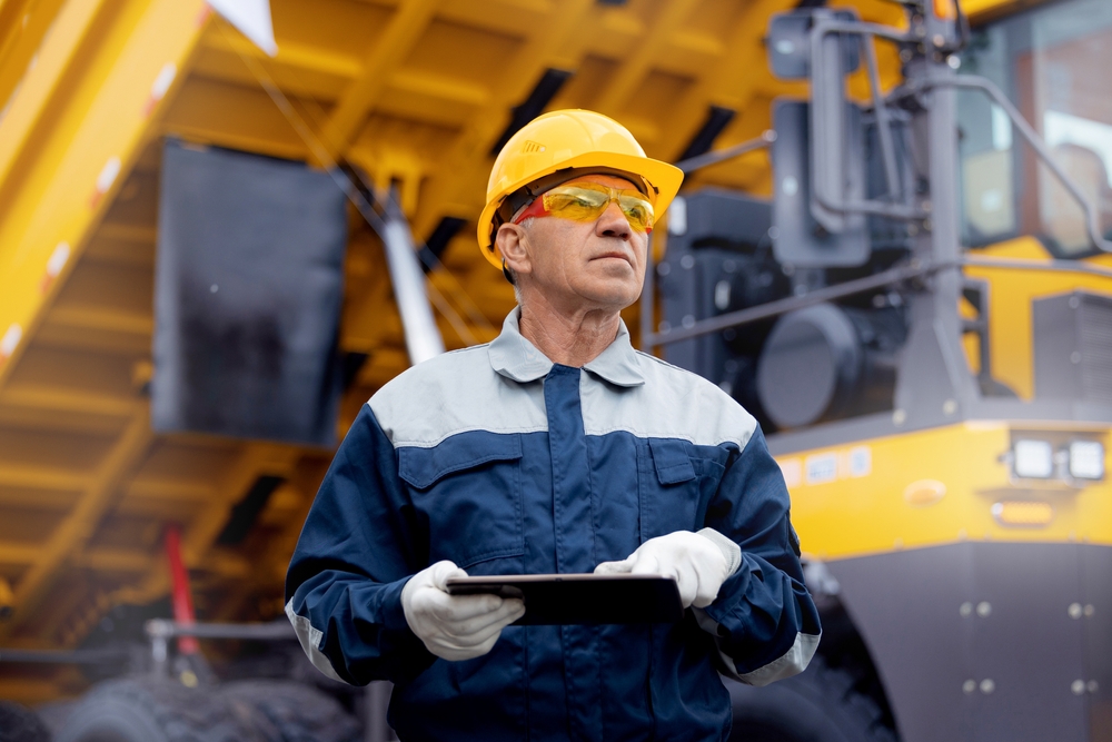 Coal,Mining,Worker,Use,Tablet,Computer,On,Background,Big,Yellow
