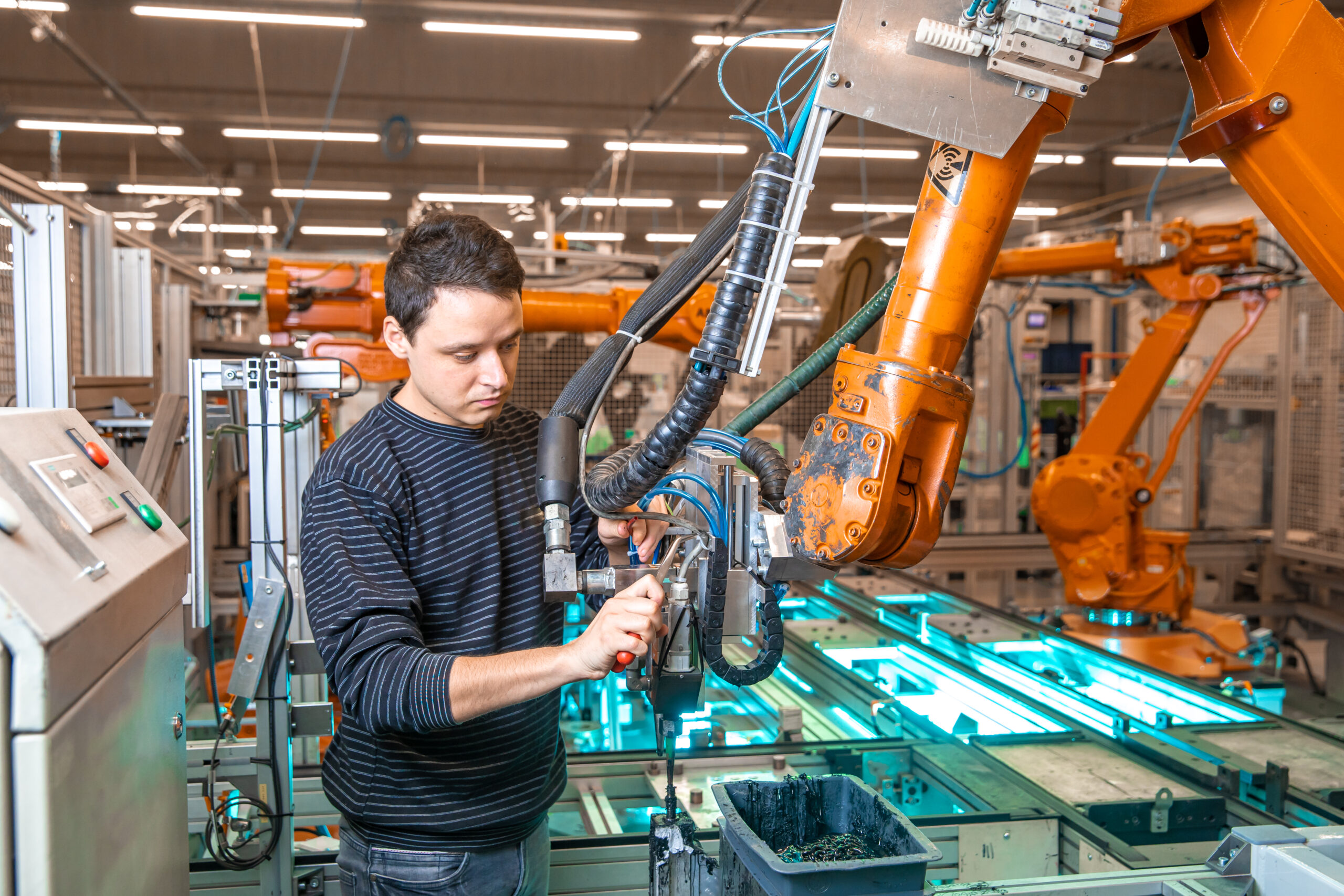 robotization of modern industry in the factory. Introduction of new robotic arms to replace human resources
