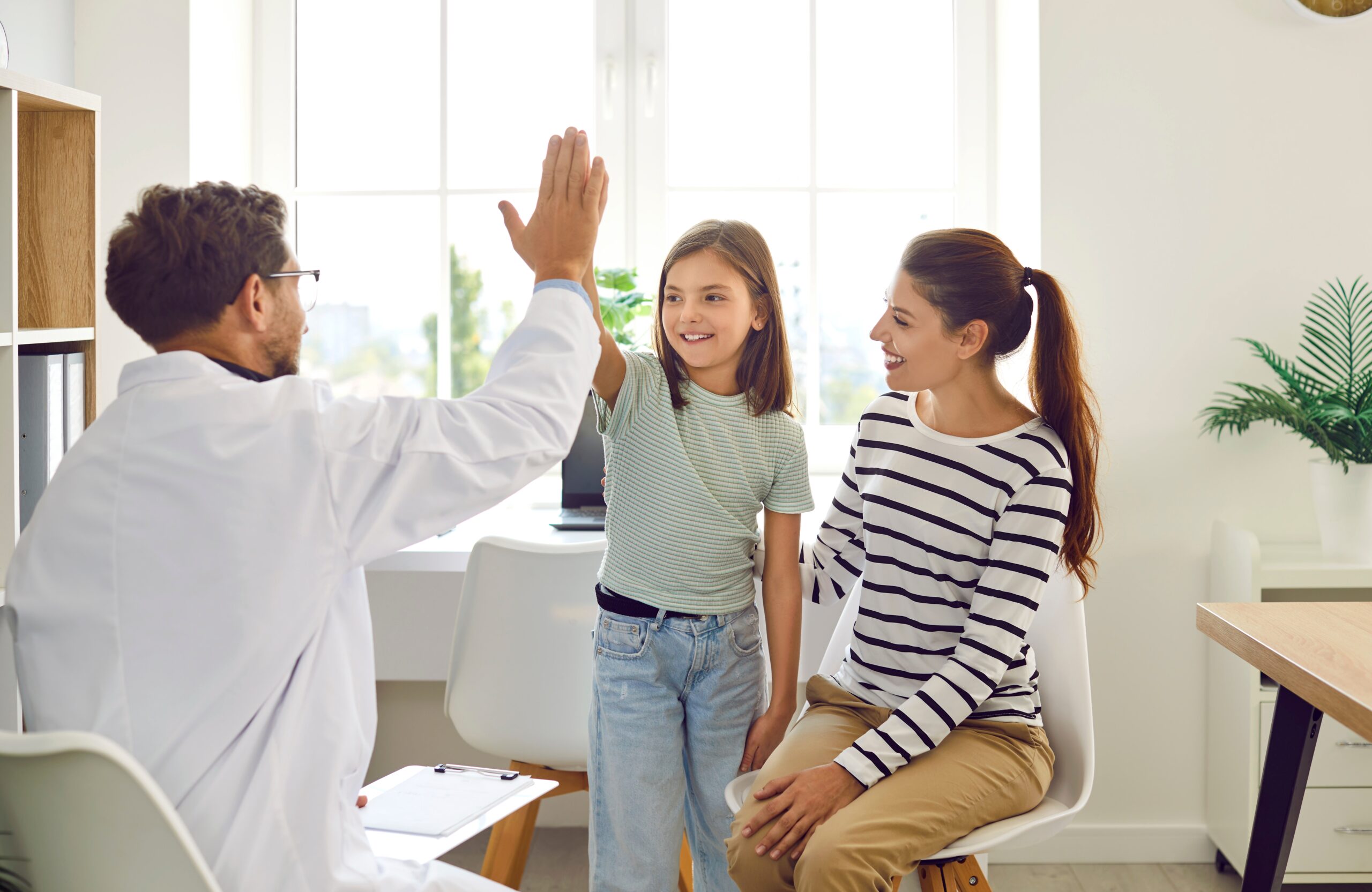 Friendly,Male,Pediatrician,Doctor,Giving,High,Five,To,A,Little